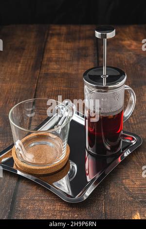 Hot winter tea served with a french press on a wooden floor Stock Photo