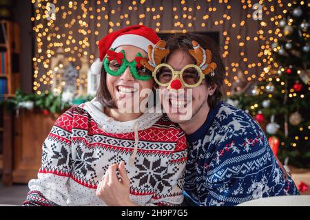 young couple of lovers celebrating having fun on christmas holy night - concept of christmas atmosphere Stock Photo