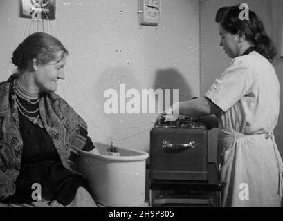 Szczawno Zdrój, 1949-02. Sanatorium. Nz. kuracjuszka (mieszkanka wsi) w gabinecie fizjoterapii. Dok³adny dzieñ wydarzenia nieustalony.  bk  PAP      Szczawno Zdroj, Feb. 1949. Sanatorium. Pictured: a patient (village resident) in a physiotherapy room.  bk  PAP Stock Photo