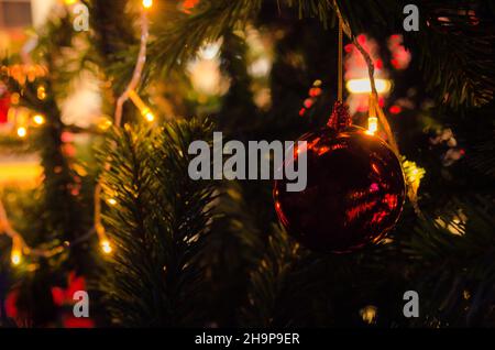 Christmas tree decorations with lights and red balls Stock Photo