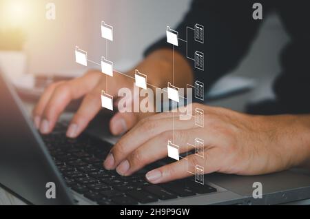 Document Management System (DMS). Businessman work on laptop online documentation database corporate. Stock Photo