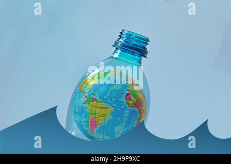 Earth planet in a plastic bottle floating on water - Concept of ecology and stop plastic pollution Stock Photo