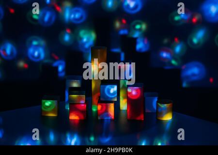 Metaverse, future, digital technology concept. Wooden constructor blocks on abstract multicolored neon lights background. Stock Photo