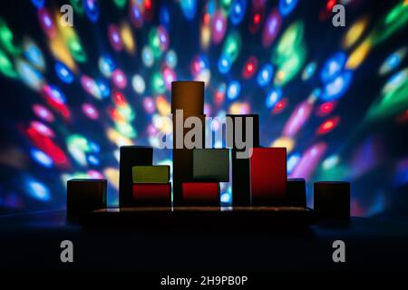 Metaverse, future, digital technology concept. Wooden constructor blocks on abstract multicolored neon lights background. Stock Photo