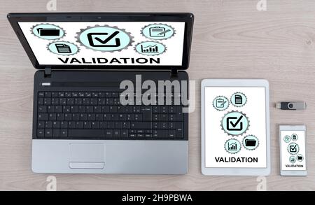 Validation concept shown on different information technology devices Stock Photo