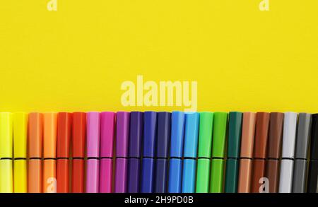 Colorful concept of creativity. The felt pens on a light yellow background Stock Photo