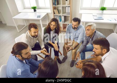 Group of people discussing something in business meeting or group therapy session Stock Photo