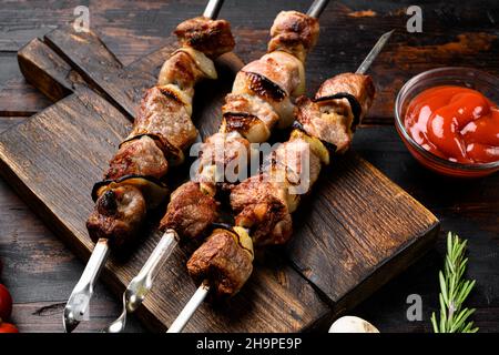 Healthy barbecued lean cubed pork kebab set, on old dark wooden table background Stock Photo