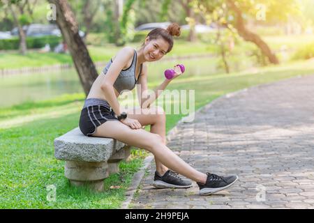 Slimming healthy women in sportswear teen cute happy enjoy fit and firm weight in the park Stock Photo