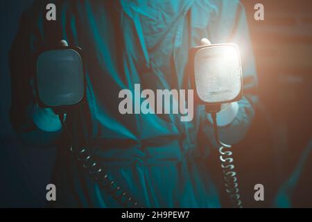 Doctor holding manual Defibrillator for Pulse generator in operating room Stock Photo