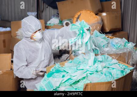 a lot of used face mask not well managed, biohazard garbage medical contaminate trash very dangerous Stock Photo