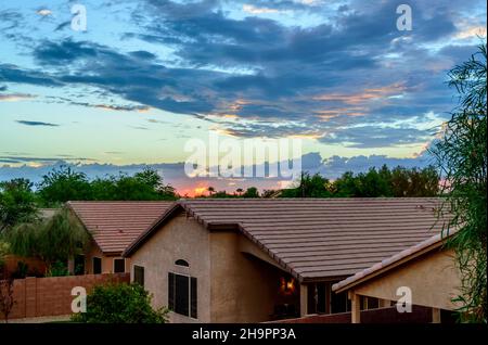 Rooftop view of Phoenix homes under a dramatic sunset sky. Stock Photo
