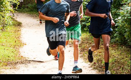 A high school running team is running together wearing spandex and socks  with long sleeves due to cold weather Stock Photo - Alamy