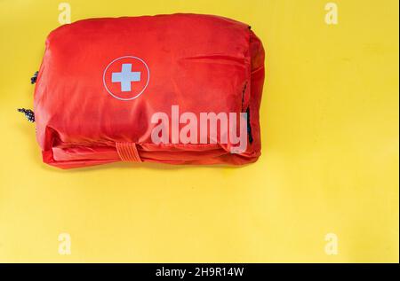 First aid kit on the yellow background Stock Photo