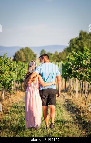 Happy married couple walking together outdoors. Follow me on journey of life. Young couple walk in vineyard Stock Photo
