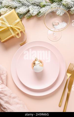 Christmas monochrome table setting with pink and gold modern decoration, silverware Stock Photo