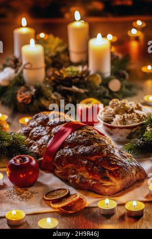 Traditional Slovak and Czech Christmas cake Vianocka - Vanocka. Handmade Christmas cake on a festively set table. Stock Photo