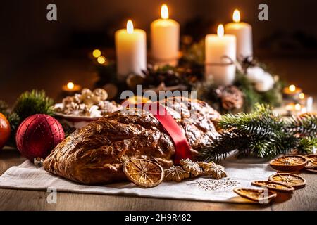Traditional Slovak and Czech Christmas cake Vianocka - Vanocka. Handmade Christmas cake on a festively set table. Stock Photo
