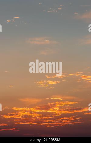 Colorful sky background after sunset. Romantic sky with orange colors. Clouds over horizon Stock Photo