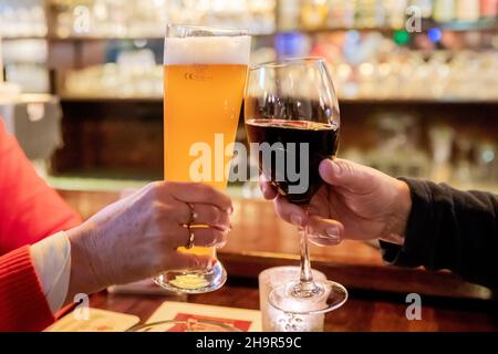 Berlin, Germany. 06th Dec, 2021. Two guests toast with wine and beer in a Berlin pub. Credit: Christoph Soeder/dpa/Alamy Live News Stock Photo