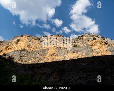 View of the red rock walls at 'Barranco de la Hoz Seca' in Jaraba (Zaragoza) during a cloudy day of Summer. Stock Photo