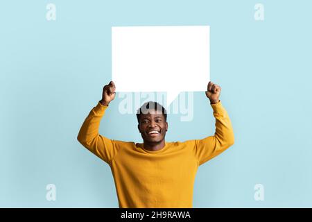 Cheerful black man holding empty communication chart Stock Photo