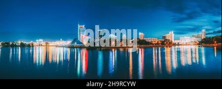 Minsk, Belarus - September 3, 2016: Panorama With Residential House Near Pobediteley Avenue And Svisloch River. Summer Evening, Night Lights Stock Photo