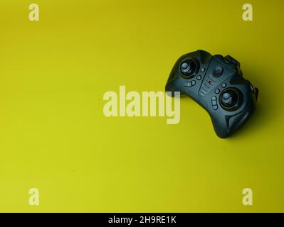 video game controller isolated on yellow background Stock Photo