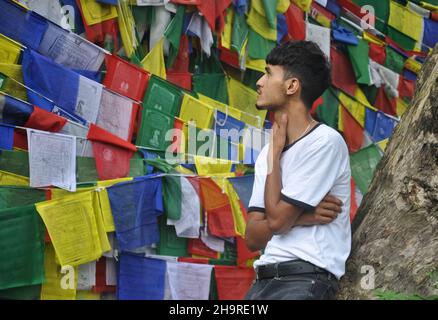 A male tourist looking to Tibetan Buddhist prayer flags in outdoors Stock Photo