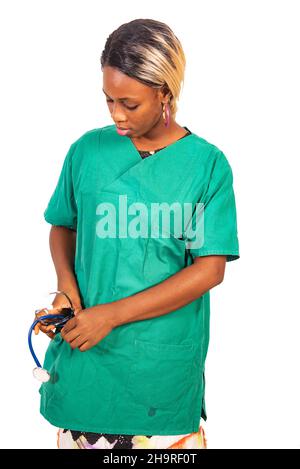 beautiful young serious woman putting the stethoscope in her pocket. Stock Photo