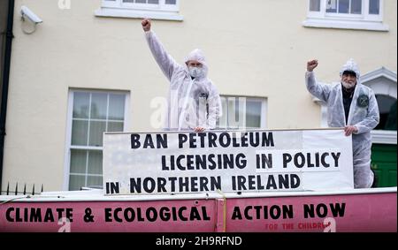 Extinction Rebellion activists Art O’Laoghaire (right), from Bray, and Louis Heath, from Sandyford, as they held a demonstration outside Sinn Fein’s headquarters in Dublin calling on the party to act now in the Northern Irish Executive to ensure a full and final ban on petroleum licensing. Picture date: Wednesday December 8, 2021. Stock Photo
