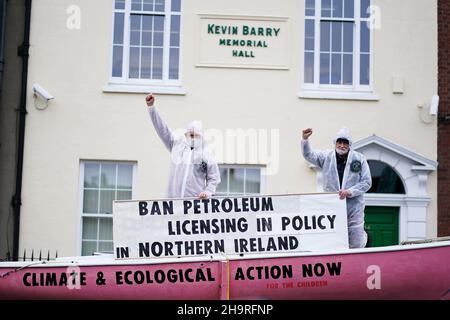 Extinction Rebellion activists Art O’Laoghaire (right), from Bray, and Louis Heath, from Sandyford, as they held a demonstration outside Sinn Fein’s headquarters in Dublin calling on the party to act now in the Northern Irish Executive to ensure a full and final ban on petroleum licensing. Picture date: Wednesday December 8, 2021. Stock Photo