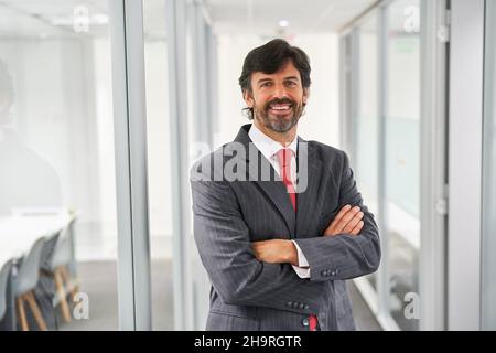 Senior business man as successful entrepreneur and boss with arms crossed Stock Photo