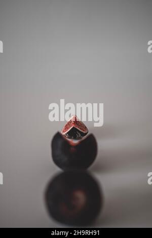 Line of figs from the whole one to a half and a piece of fig. Top view of figs Stock Photo