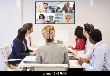Online meeting with video conference from the business team in the conference room with colleagues connected from the home office Stock Photo
