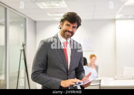 Business man as a manager with competence and experience on the tablet computer Stock Photo