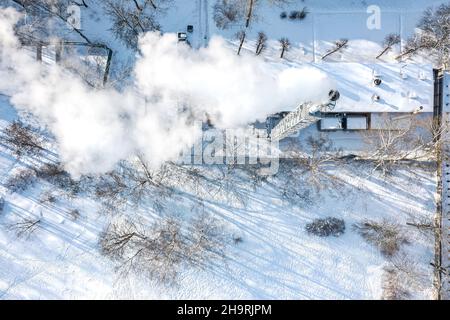 boiler-house with steaming chimney on chilly winter day. aerial top view from flying drone. Stock Photo