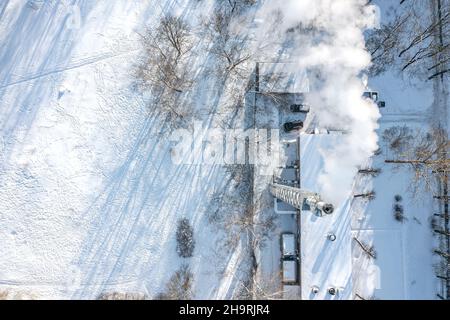 aerial top view of boiler-house plant with steaming chimney on chilly winter day Stock Photo