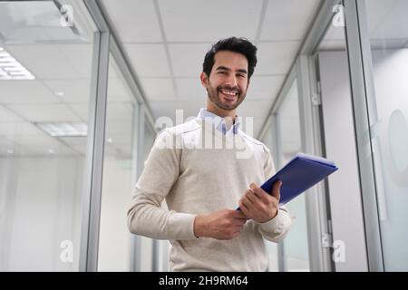 Happy young business man as a startup founder with documents in the office Stock Photo