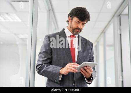 Successful business man as manager or consultant using tablet computer in the office Stock Photo