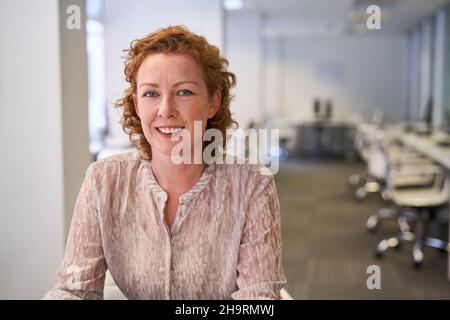 Smiling business woman as a start-up founder or managing director in an open-plan office Stock Photo
