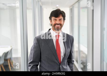 Smiling business man as a successful manager or consultant in the office Stock Photo