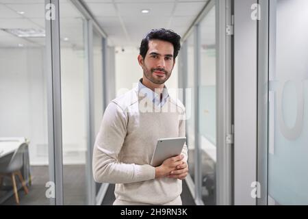 Young businessman as a business start-up founder using tablet computer in the office Stock Photo