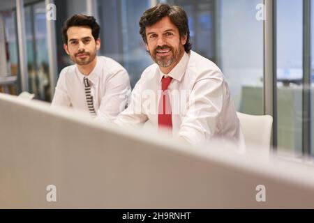 Two business colleagues as managers and trainees work together in the consultant team Stock Photo
