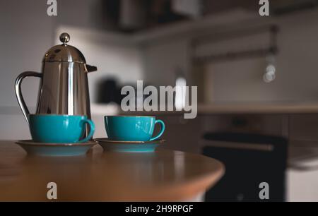 Teapot and two cups on the table in the morning. Stock Photo