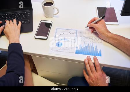 Hands of business man analyzing financial planning data at desk Stock Photo