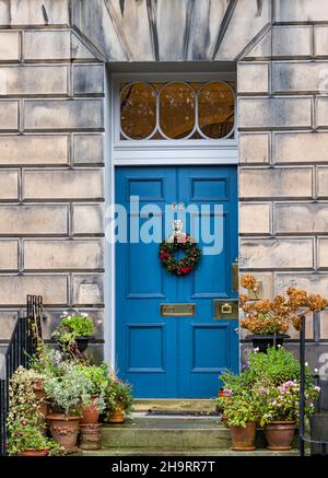 Georgian townhouse blue painted front door with Christmas wreath, Edinburgh New Town, Scotland, UK Stock Photo