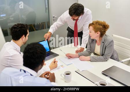 Business people doing financial analysis and strategy planning on the PC with consultant in a meeting Stock Photo