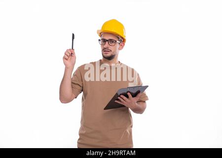 Builder Holding Clipboard in Hands Pointing with Pen Up. Construction Wokrer Having Good Idea. Stock Photo
