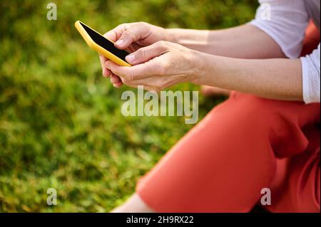 Womans hands holding smartphone reading message Stock Photo